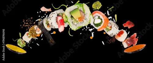 Obraz  z motywem Pieces of delicious japanese sushi frozen in the air.