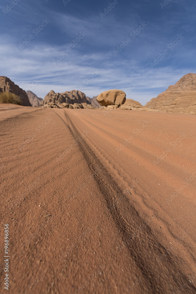 Long car trail to the mushroom rock in Wadi Rum desert, Jordan