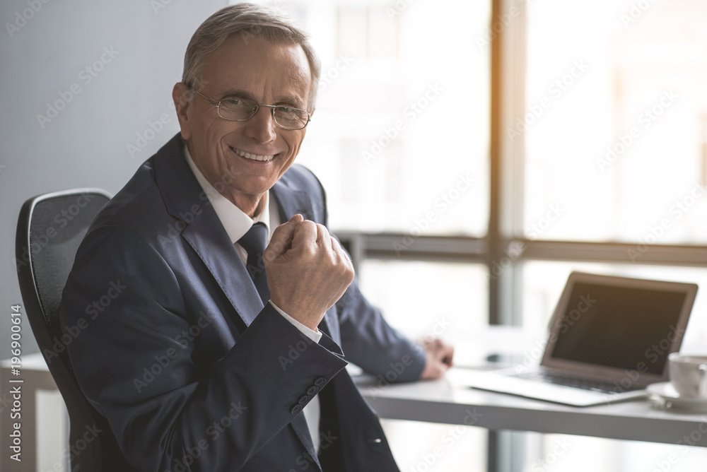 Yes. Portrait of beaming mature male looking at camera while having job with gadget. Pleased worker during occupation concept Yes. Portrait of beaming mature male looking at camera while having job with gadget. Pleased worker during occupation concept