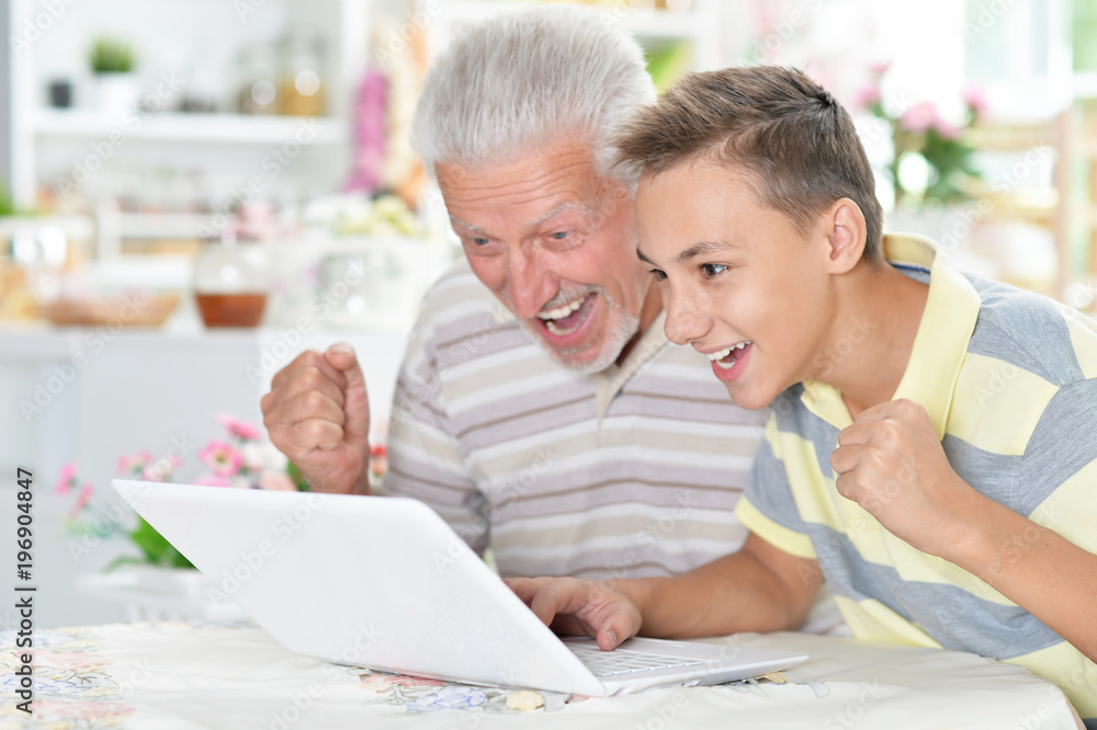 portrait of boy and grandfather with a laptop portrait of boy and grandfather with a laptop