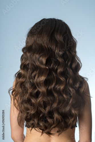 girl with long curly hair from behind