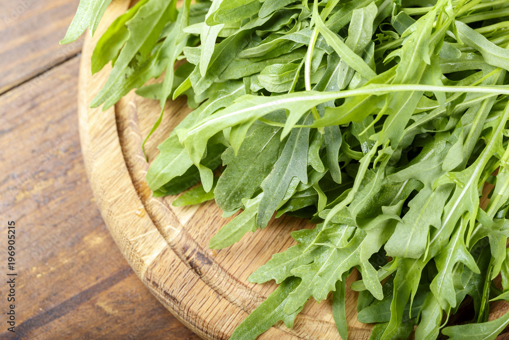 Fresh arugula leaves, rucola, fresh rucola in a plate, space for text. Fresh arugula leaves, rucola, fresh rucola in a plate, space for text.