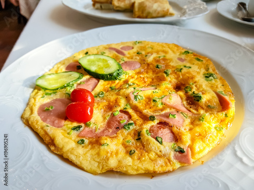 Omelette with bacon, cucumbers and tomatoes
