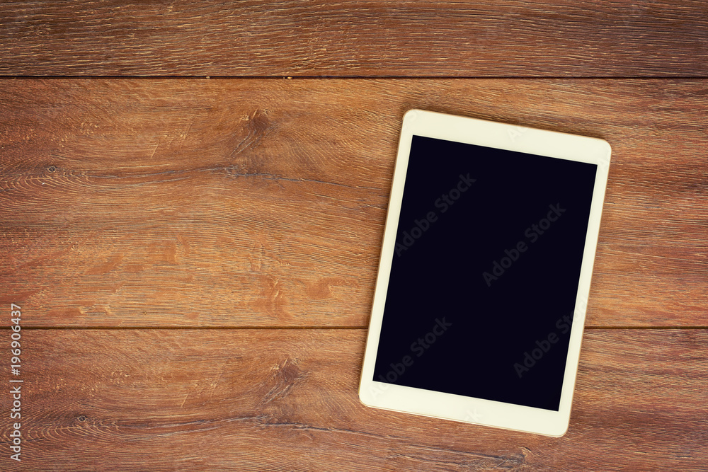 Blank Tablet computer on wood table background with space for text. Blank Tablet computer on wood table background with space for text.