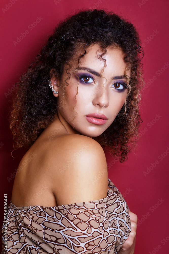 Close-up portrait of a beautiful young african american female fashion model with curly hair