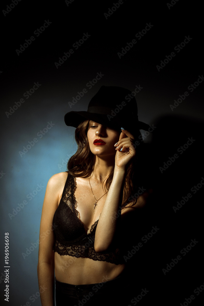 Gorgeous lady with curly hairstyle in dark studio Gorgeous lady with curly hairstyle in dark studio