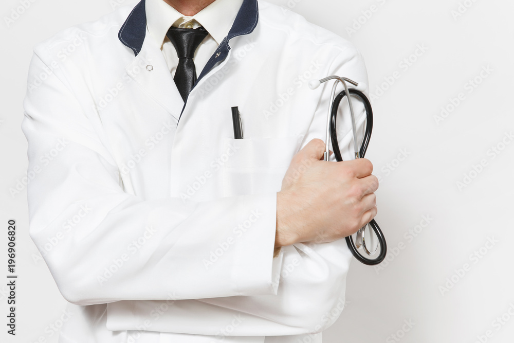 Close up cropped shot young doctor man isolated on white background. Male doctor in medical uniform holding stethoscope, holding hands folded. Healthcare personnel health medicine concept. Copy space. Close up cropped shot young doctor man isolated on white background. Male doctor in medical uniform holding stethoscope, holding hands folded. Healthcare personnel health medicine concept. Copy space.