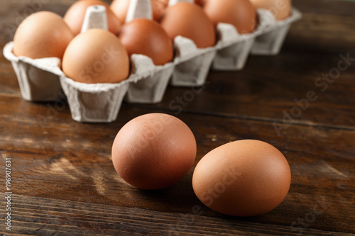 two chicken eggs on the background of a tray with eggs