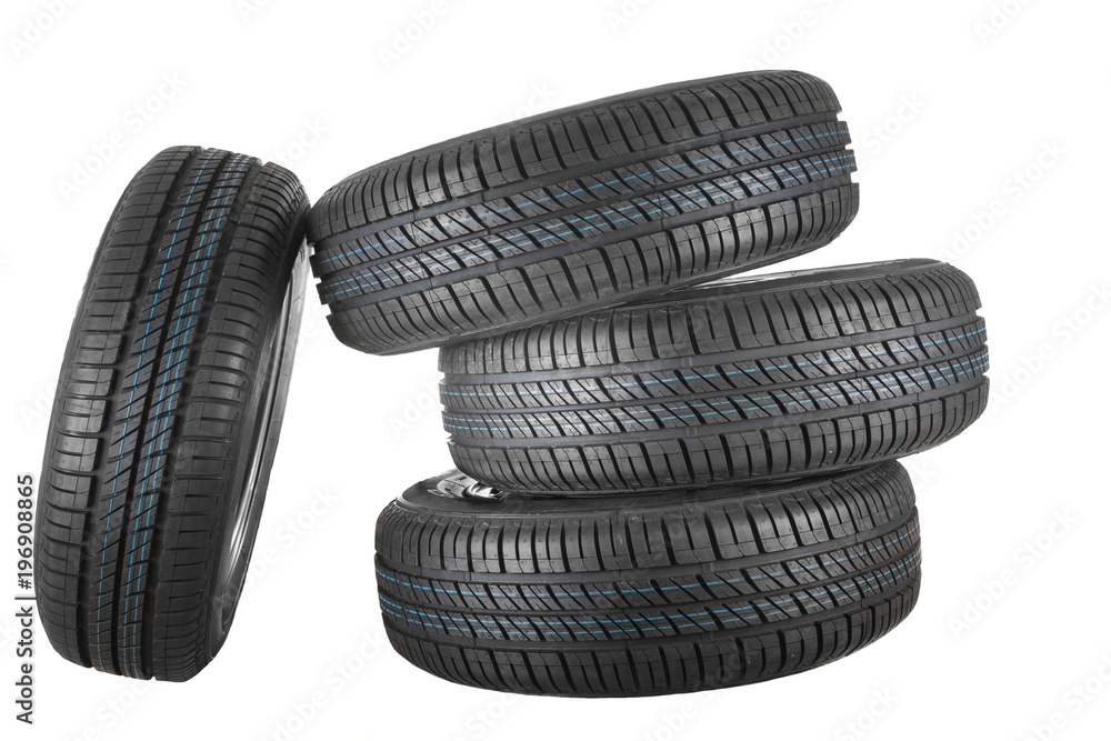 New and unused car tires against isolated background New and unused car tires against isolated background