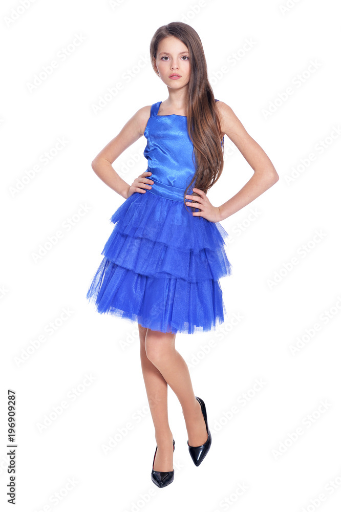 Happy little girl in blue dress posing  isolated