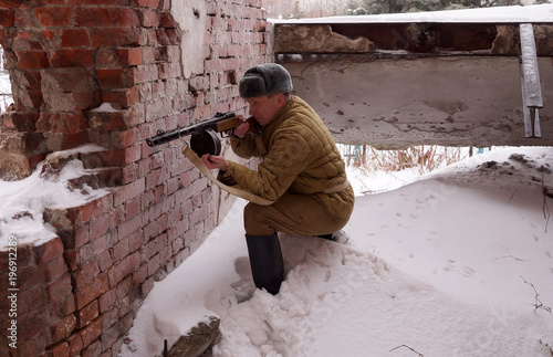 Fighter of Red army with the machine gun in ruins of Stalingrad