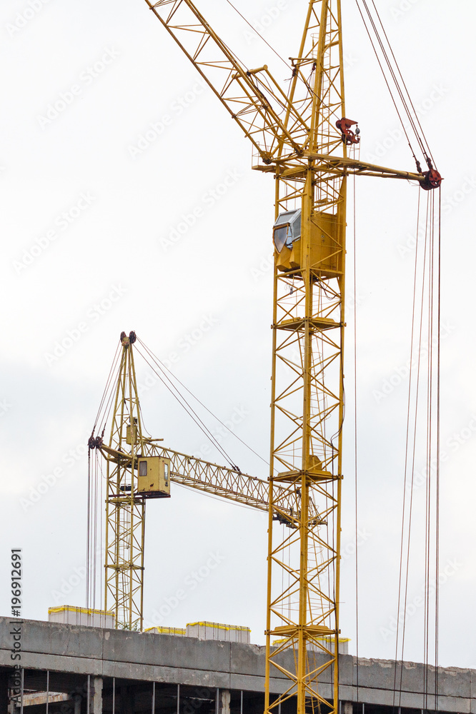 Building crane under construction against blue sky Building crane under construction against blue sky