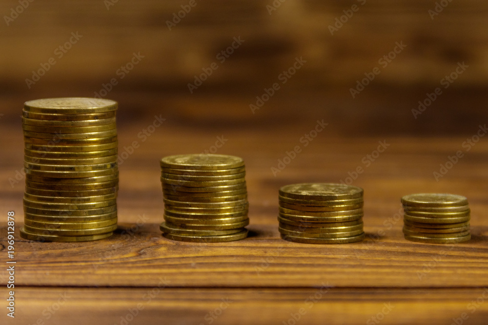 Stacks of golden coins on wooden background Stacks of golden coins on wooden background