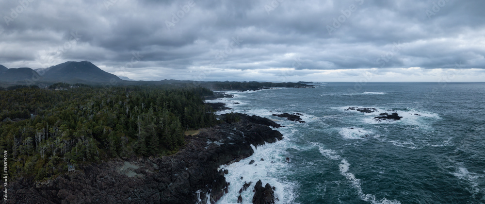 Aerial panoramic seascape view of a rocky Pacifc Coast during a gloomy winter sunset. Taken near Ucluelet, Vancouver Island, British Columbia, Canada.