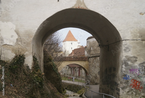 A defense tower seen through one of the arched gates of the Graft Bastion, Romania, Transylvania, Brasov (Bastionul Graft) 1515- 1521 photo