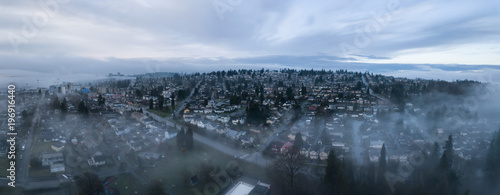 Aerial panoramic view of the residential neighborhood in the city during a foggy sunrise. Taken in New Westminster  Greater Vancouver  British Columbia  Canada.