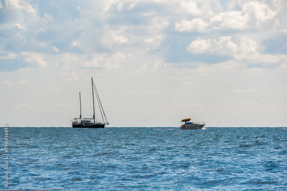 the rocky shore and sailboat at sea. Fiolent, Crimea the rocky shore and sailboat at sea. Fiolent, Crimea