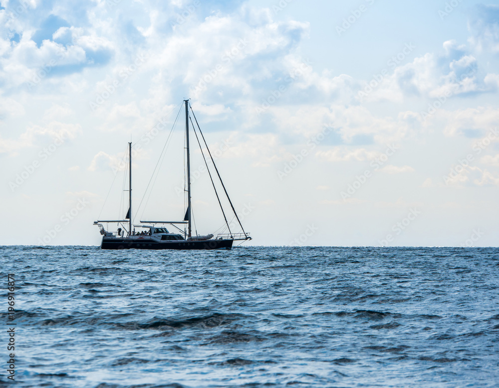 Sailing yacht in the open Sea. Blue water.