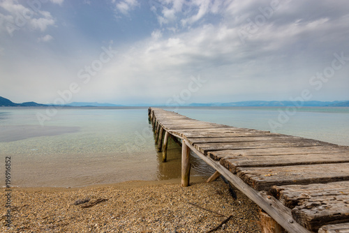 Old wooden pier and sea in cloudy day. Eastern side of Corfu island.