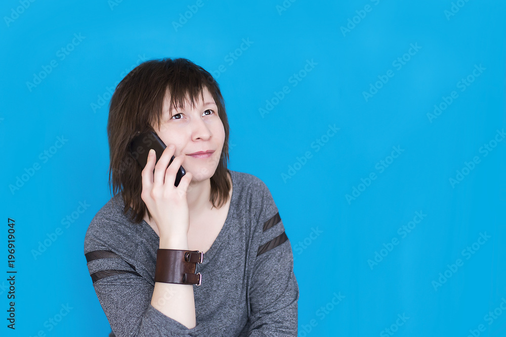 girl with phone on blue background girl with phone on blue background