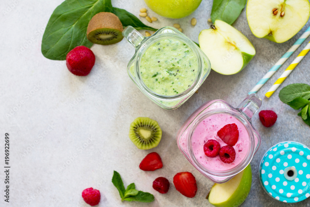 Fresh fruit smoothie and green smoothies on a gray stone or slate background. Healthy vegan food concept. Copy space, top view flat lay background. Fresh fruit smoothie and green smoothies on a gray stone or slate background. Healthy vegan food concept. Copy space, top view flat lay background.