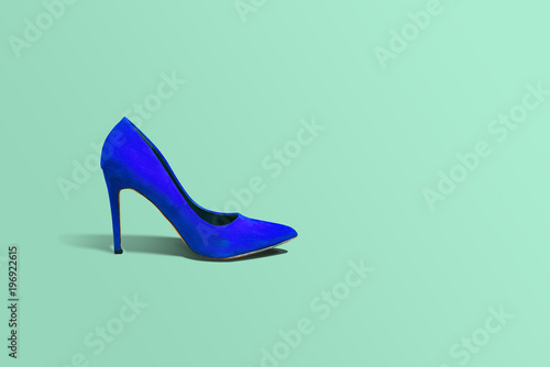 High heels, blue high heel on a green pastel background. Fashion concept, catwalk. Online store, fashion store, sale of shoes. Footwear Female shoes. A few different shoes.