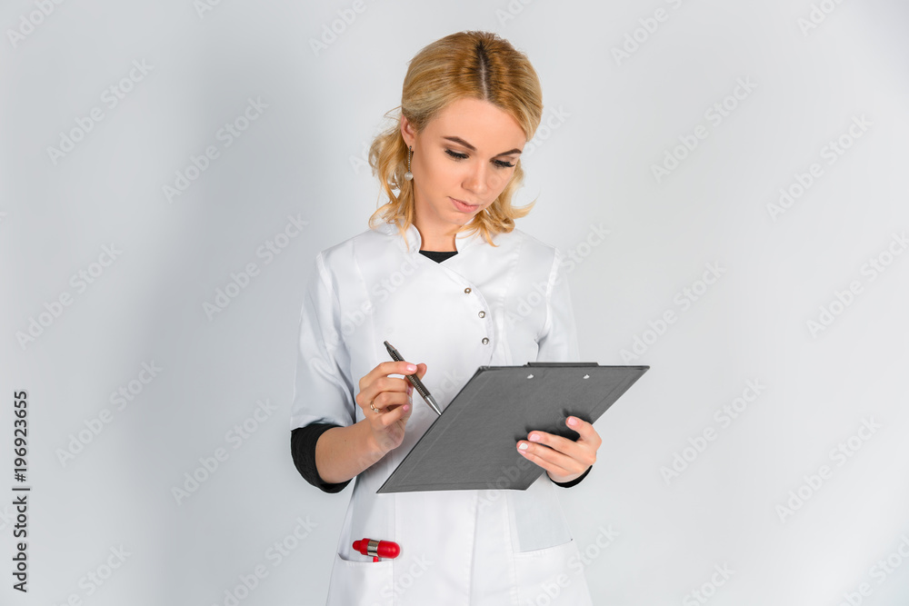 A female doctor with a folder, standing on white background A female doctor with a folder, standing on white background