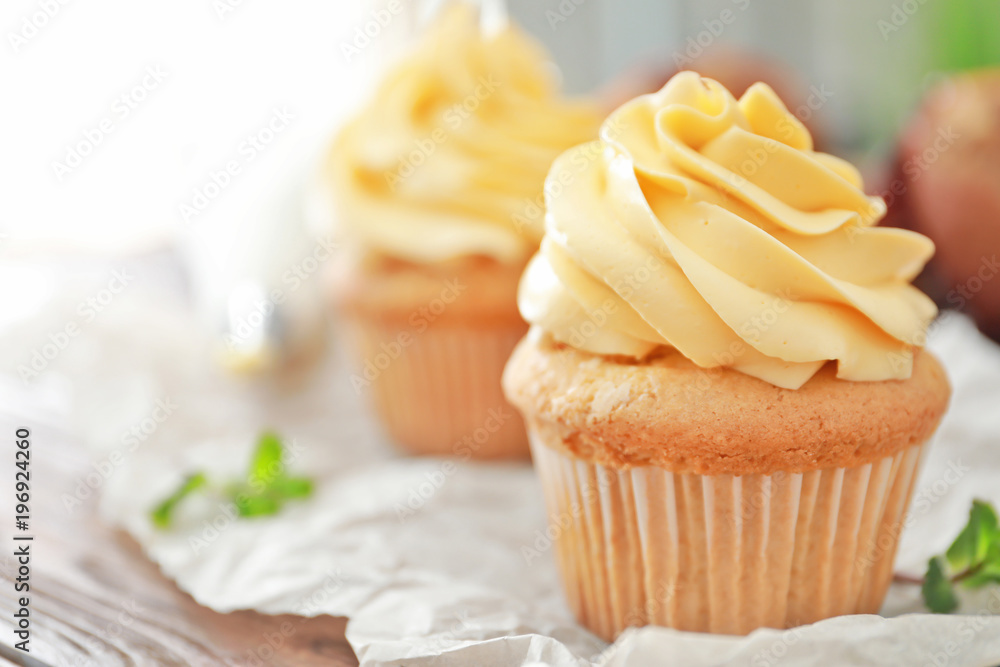 Tasty cupcake with cream on table Tasty cupcake with cream on table