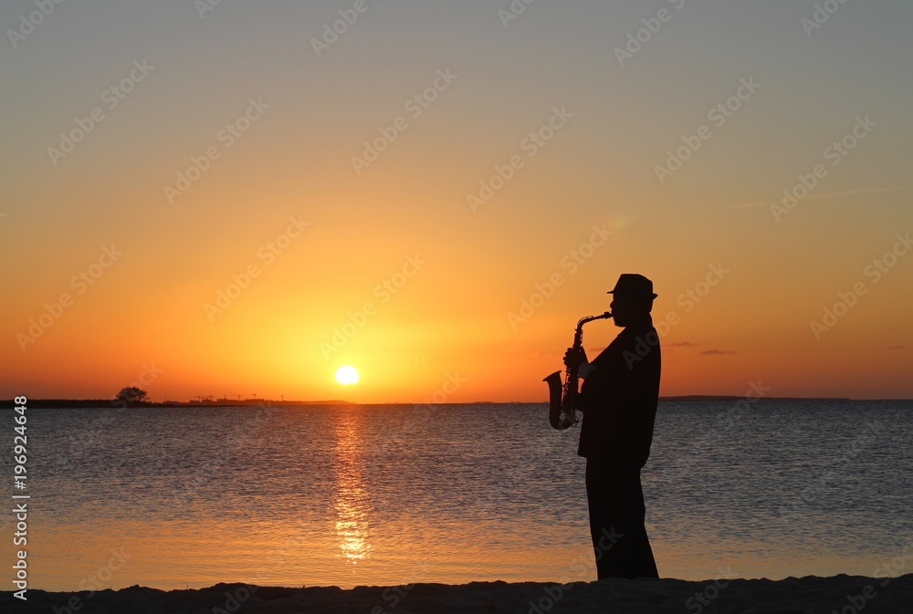 Cuban musician playing saxophone in the sunset