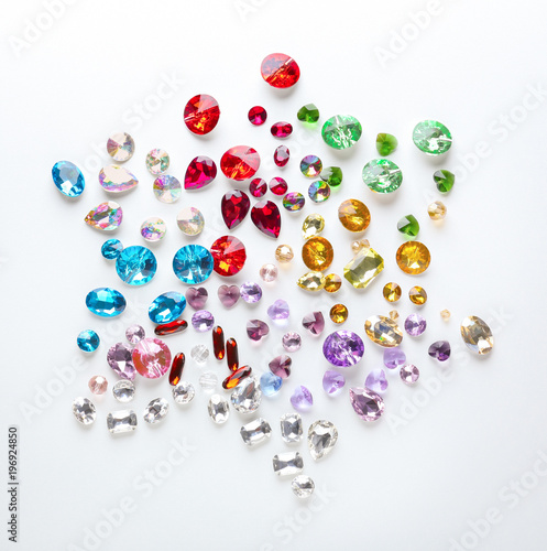 Composition of colorful precious stones for jewellery on white background