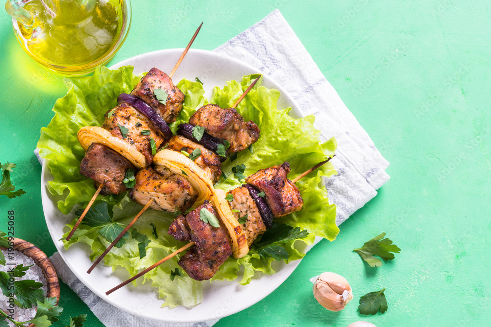 Grilled shish kebab or shashlik on green table.