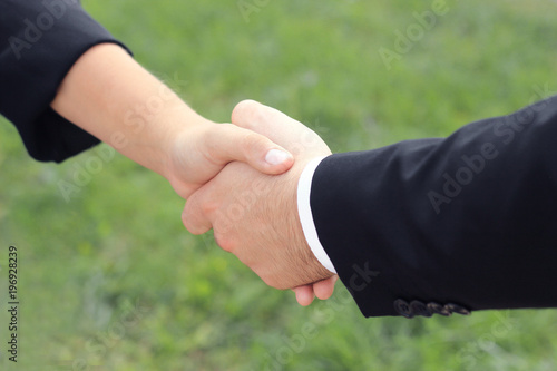 close up. the handshake business partners in the outdoors.photo with copy space.