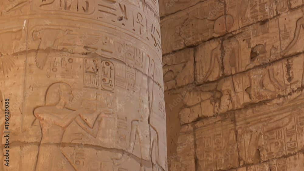 The stone columns with relief carving in Ancient Egyptian temple complex. The stone columns with relief carving in Ancient Egyptian temple complex.