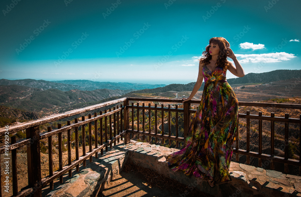 Φωτογραφία Outdoor summer portrait of young beautiful lady wearing long evening dress in bright colors and colorful print