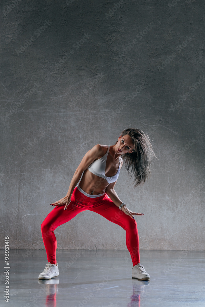 Young beautiful female dancer is posing in the studio Young beautiful female dancer is posing in the studio