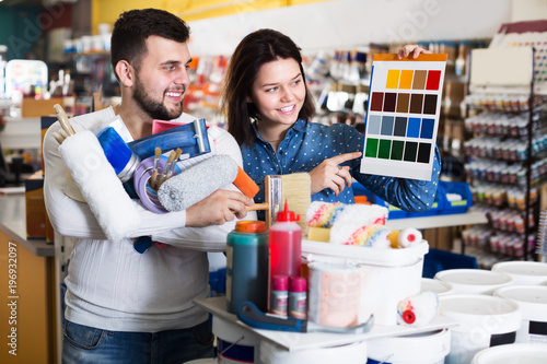 Couple in paint supplies store