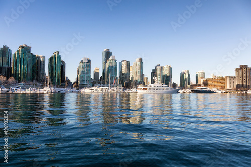 Downtown City Skyline during a vibrant winter sunrise. Taken in Coal Harbour, Vancouver, British Columbia, Canada.