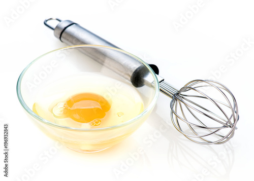 open egg in glass bowl on white background