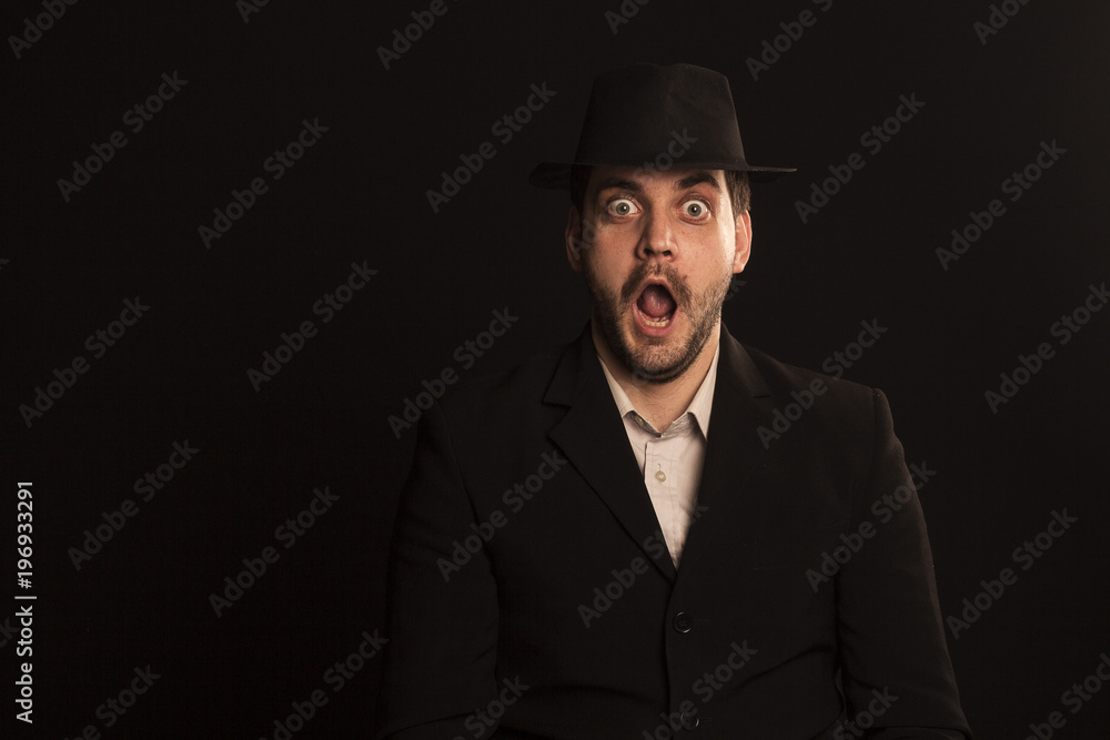 Emotional gay in a hat on a black background Emotional gay in a hat on a black background