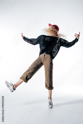 Young beautiful female dancer is posing in the studio