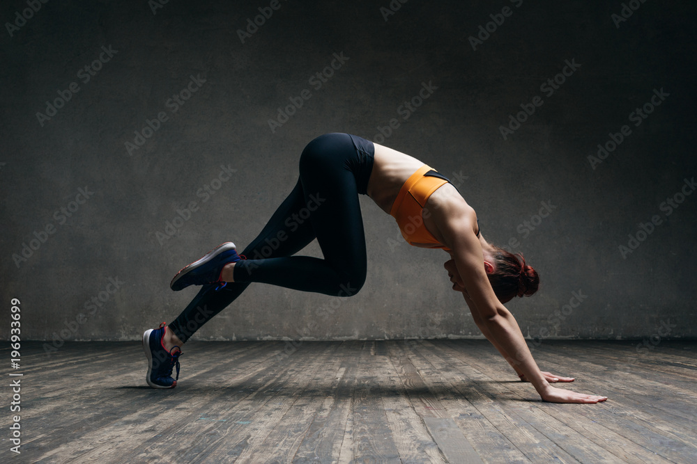 Young beautiful athlete is posing in studio Young beautiful athlete is posing in studio