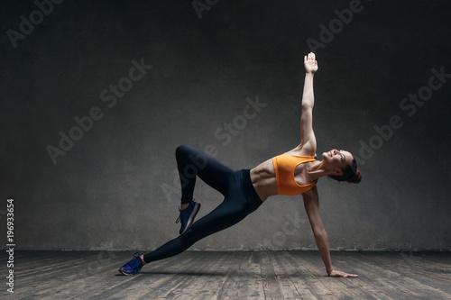 Young beautiful athlete is posing in studio © Alexander Y