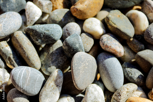 beautiful, multicolored pebbles pebbles lie on the seashore