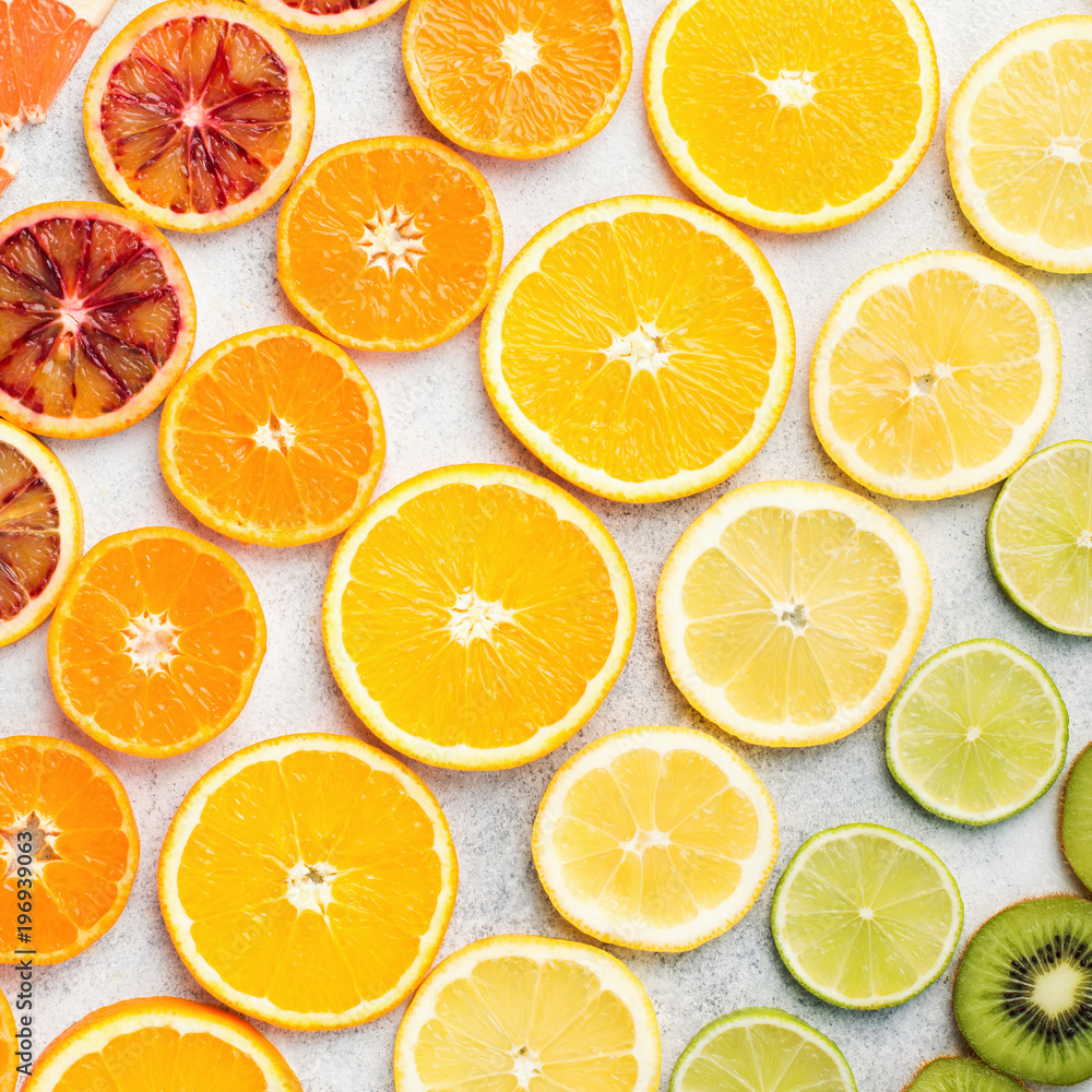 Pattern, different varieties of citrus fruits, oranges, lemons, limes, kiwis arranged in the rows, diagonal, square. Colorful background, top view