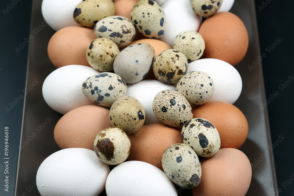 different quail and chicken eggs lie together on a plate. different quail and chicken eggs lie together on a plate.