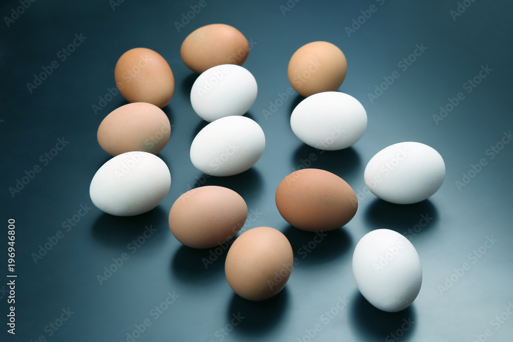 different chicken eggs lie on dark background. different chicken eggs lie on dark background.