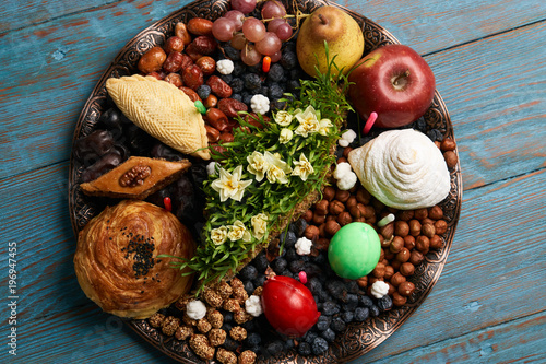 Novruz tray plate with Azerbaijan national pastry pakhlava , shekerbura, gogal and dry fruit snack on rustic table background. spring new year celebration top view
