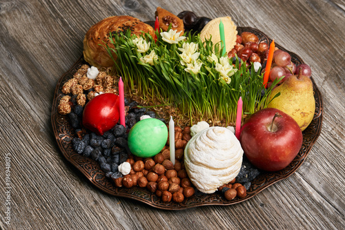 Novruz tray plate with Azerbaijan national pastry pakhlava , shekerbura, gogal and dry fruit snack on rustic table background. spring new year celebration top view
