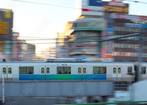 Tokyo,Japan-March 17, 2018: Panning of commuter train running near Takadanobaba station early in the Saturday morning.
 photo
