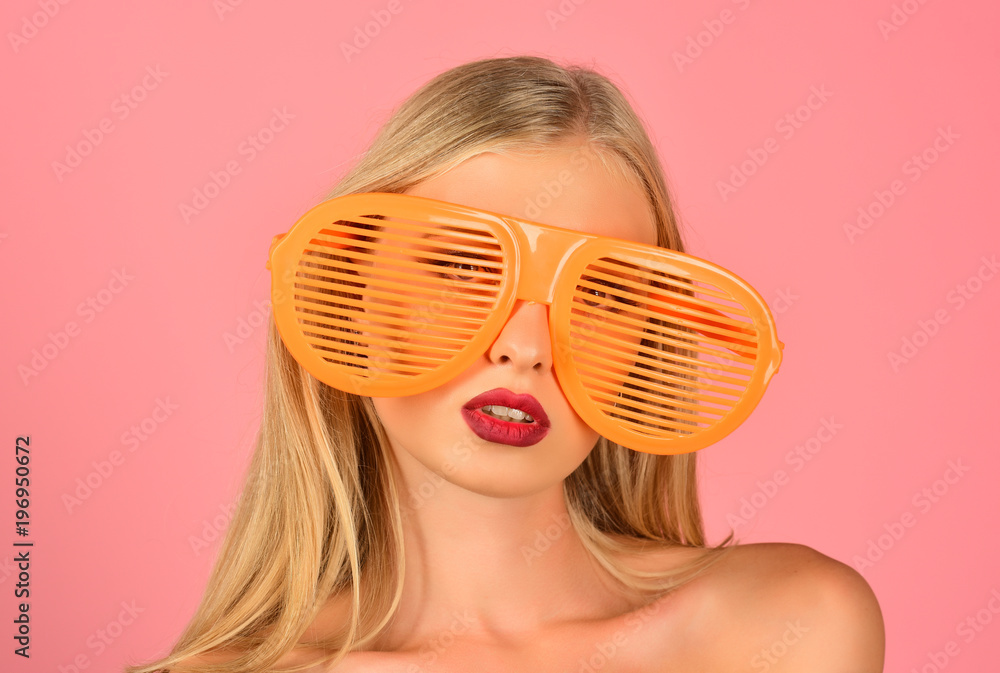 Summer style. Stripes. Attractive female model with long hair posing in glamour plastic fashion sunglasses. Summer, holidays and vacation concept - stylish woman in retro sunglasses. Stock-foto | Adobe Stock